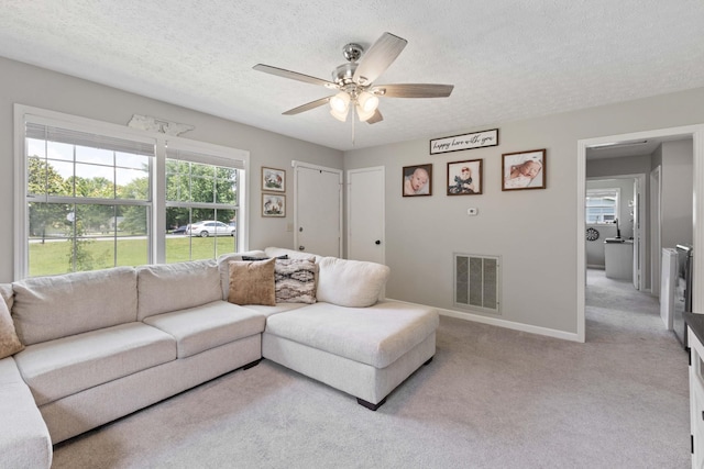 1040 Rebecca Dr, Burns, TN 37029 - carpeted living room featuring ceiling fan, a textured ceiling, and baseboards