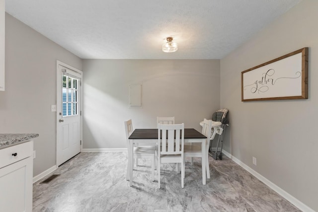 1040 Rebecca Dr, Burns, TN 37029 - dining space with a textured ceiling and baseboards