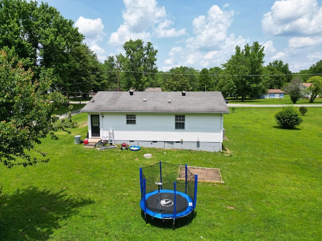 1040 Rebecca Dr, Burns, TN 37029 - rear view of property with a trampoline, entry steps, and a yard