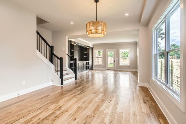 549B Stevenson St, Nashville, TN 37209 - unfurnished living room with light wood-style floors, stairway, baseboards, and recessed lighting