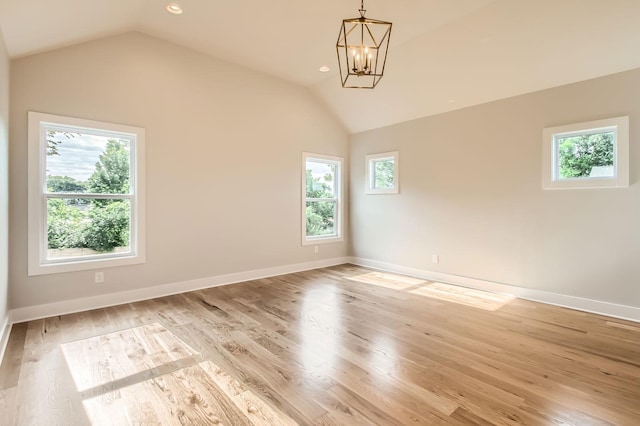 549B Stevenson St, Nashville, TN 37209 - unfurnished room featuring healthy amount of natural light, lofted ceiling, a chandelier, baseboards, and light wood finished floors