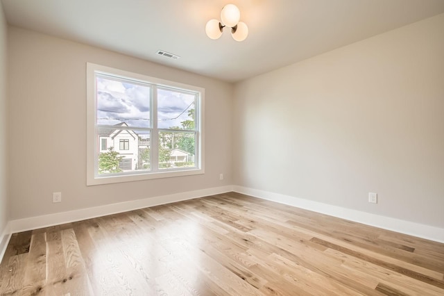 549B Stevenson St, Nashville, TN 37209 - empty room featuring wood finished floors, baseboards, and a chandelier
