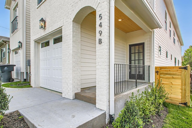 549B Stevenson St, Nashville, TN 37209 - view of exterior entry featuring brick siding, a garage, and covered porch