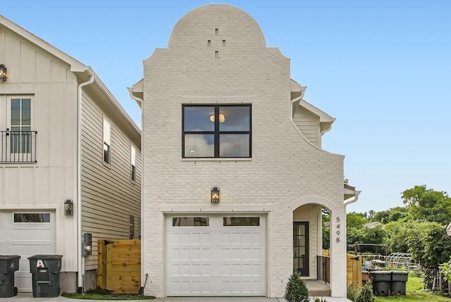 549B Stevenson St, Nashville, TN 37209 - view of front of property featuring an attached garage, brick siding, board and batten siding, and concrete driveway