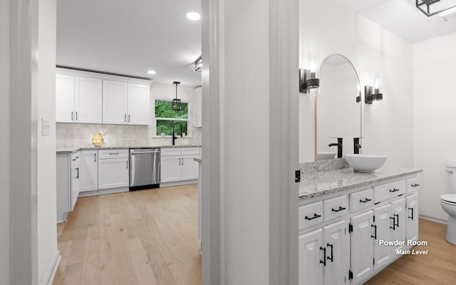 1234 Mountain Brook Cir, Signal Mountain, TN 37377 - bar with stainless steel dishwasher, a sink, light wood-style floors, decorative backsplash, and recessed lighting
