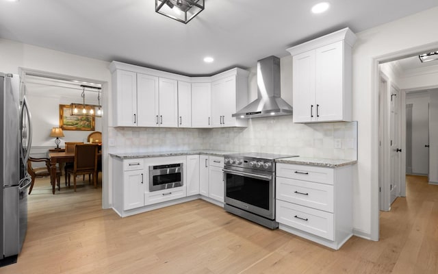 1234 Mountain Brook Cir, Signal Mountain, TN 37377 - kitchen with stainless steel appliances, wall chimney range hood, tasteful backsplash, white cabinetry, and recessed lighting