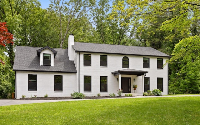 1234 Mountain Brook Cir, Signal Mountain, TN 37377 - colonial home featuring a chimney, a front lawn, brick siding, a shingled roof, and view of wooded area