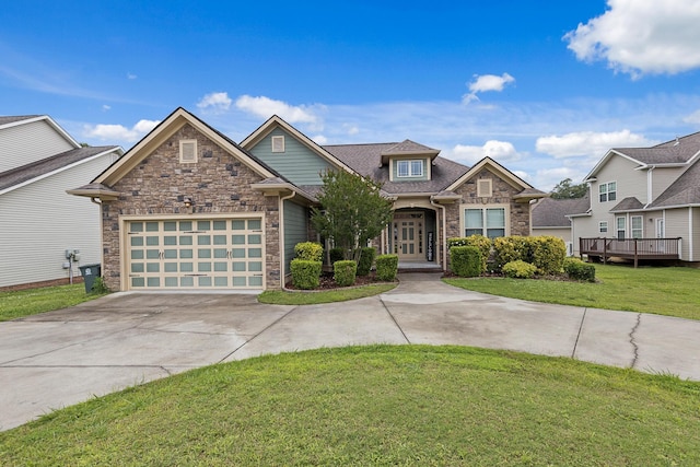 849 Graysville Rd, Chattanooga, TN 37421 - view of front of house with stone siding, a front yard, concrete driveway, and an attached garage