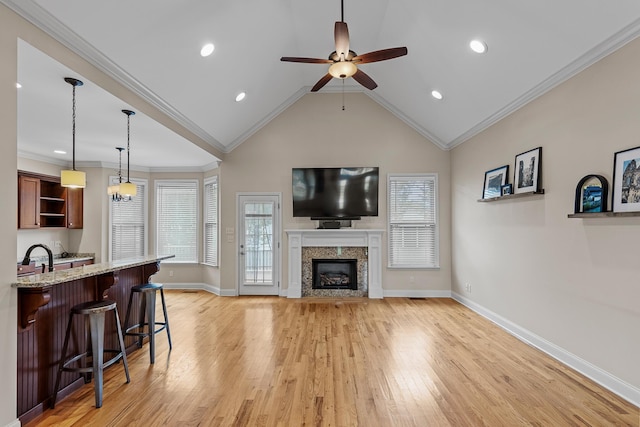 849 Graysville Rd, Chattanooga, TN 37421 - living room with light wood-style floors, a ceiling fan, baseboards, a fireplace, and vaulted ceiling