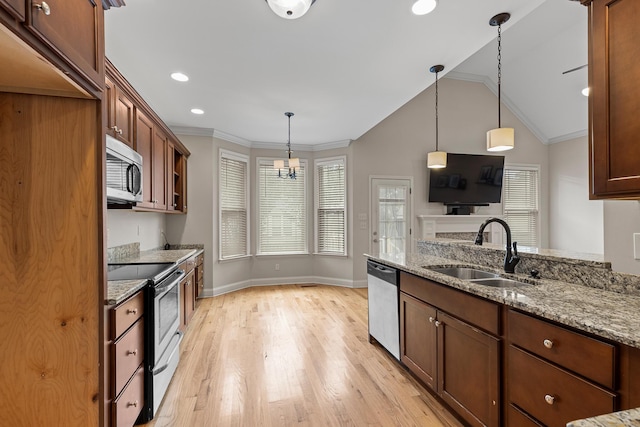 849 Graysville Rd, Chattanooga, TN 37421 - kitchen with a sink, stainless steel appliances, light wood-style flooring, light stone countertops, and vaulted ceiling