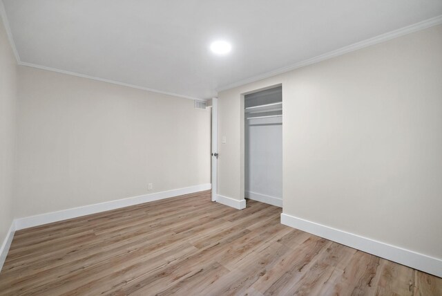 117 Robert Yoest Dr, Antioch, TN 37013 - unfurnished bedroom featuring crown molding, baseboards, light wood finished floors, and a closet