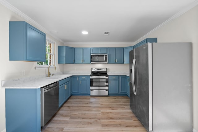 117 Robert Yoest Dr, Antioch, TN 37013 - kitchen with appliances with stainless steel finishes, a sink, blue cabinets, crown molding, and light wood-style flooring