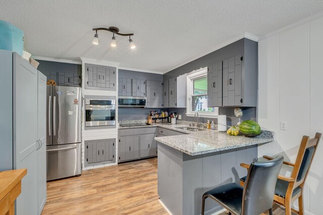 2729 Heights Circle Rd, Greenbrier, TN 37073 - kitchen with appliances with stainless steel finishes, gray cabinets, a sink, a peninsula, and crown molding