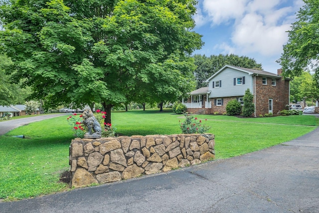 2729 Heights Circle Rd, Greenbrier, TN 37073 - view of front facade with a front yard, a chimney, and brick siding