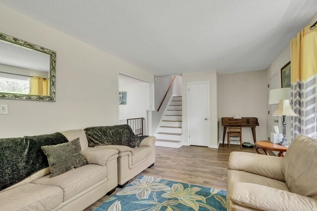 2729 Heights Circle Rd, Greenbrier, TN 37073 - living room with wood finished floors, stairs, and a textured ceiling