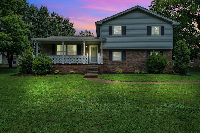 2729 Heights Circle Rd, Greenbrier, TN 37073 - tri-level home with a porch, a lawn, and brick siding