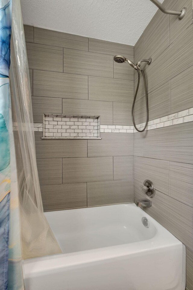 2729 Heights Circle Rd, Greenbrier, TN 37073 - bathroom featuring shower / tub combo with curtain and a textured ceiling