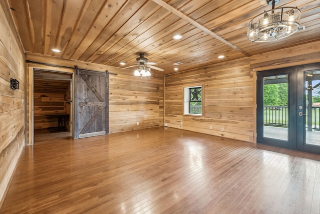 210 S 3rd St, Dickson, TN 37055 - spare room featuring a barn door, wooden ceiling, wood walls, french doors, and hardwood / wood-style flooring