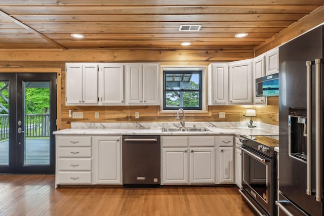 210 S 3rd St, Dickson, TN 37055 - kitchen with stainless steel appliances, wooden ceiling, a sink, white cabinetry, and french doors