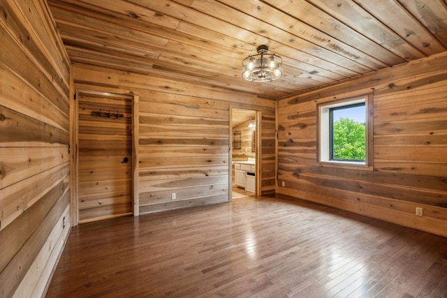 210 S 3rd St, Dickson, TN 37055 - empty room with wood ceiling, wooden walls, wood finished floors, a chandelier, and a sauna / steam room