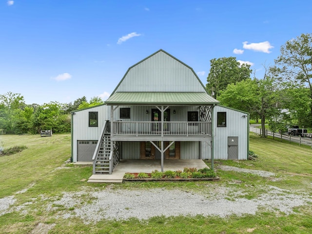210 S 3rd St, Dickson, TN 37055 - rear view of house with a gambrel roof, a patio area, stairs, a garage, and metal roof
