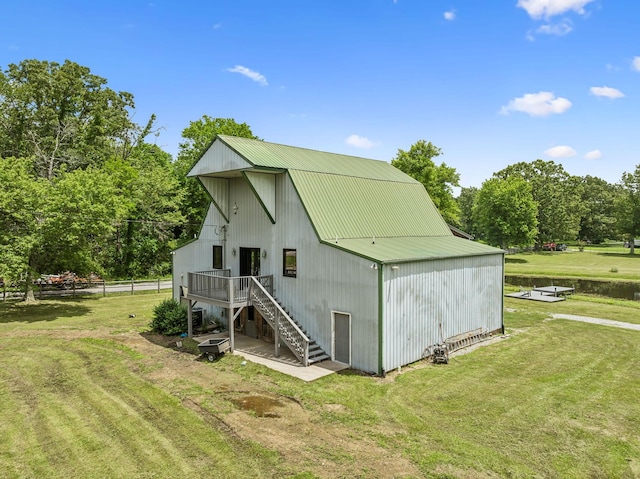 210 S 3rd St, Dickson, TN 37055 - back of property with stairs, a yard, metal roof, and view of scattered trees