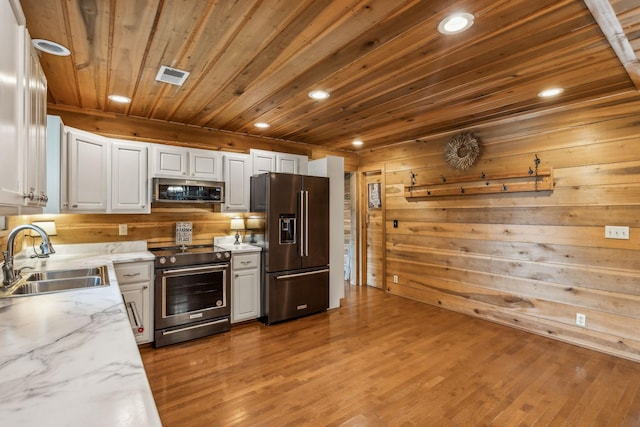 210 S 3rd St, Dickson, TN 37055 - kitchen with appliances with stainless steel finishes, a sink, wooden ceiling, white cabinets, and recessed lighting