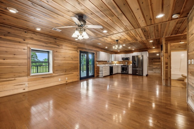 210 S 3rd St, Dickson, TN 37055 - unfurnished living room with wooden ceiling, plenty of natural light, wooden walls, dark wood-type flooring, and a ceiling fan