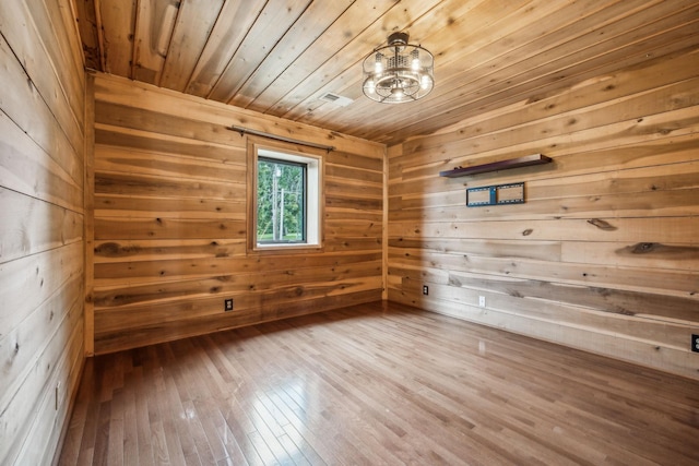 210 S 3rd St, Dickson, TN 37055 - empty room featuring a relaxing sauna, wood ceiling, wood walls, a chandelier, and wood-type flooring
