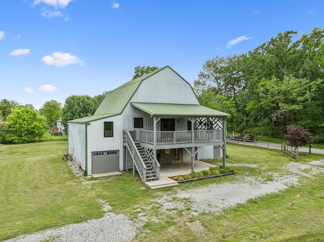 210 S 3rd St, Dickson, TN 37055 - view of front of house featuring metal roof, stairs, a deck, driveway, and a garage