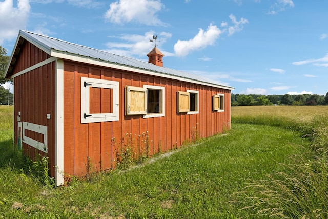 210 S 3rd St, Dickson, TN 37055 - view of property exterior featuring metal roof, an outbuilding, board and batten siding, and a yard