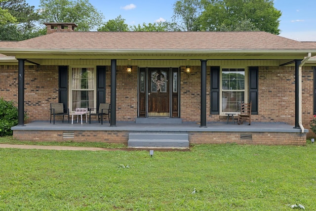 1106 5th Ave, Lawrenceburg, TN 38464 - entrance to property with covered porch, a yard, brick siding, and a shingled roof
