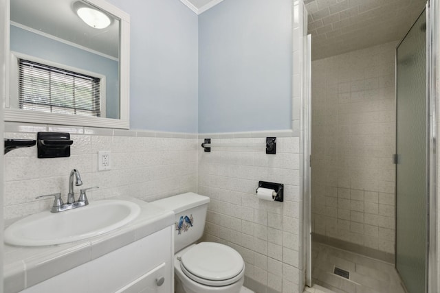 1106 5th Ave, Lawrenceburg, TN 38464 - bathroom with a shower stall, ornamental molding, toilet, vanity, and tile walls