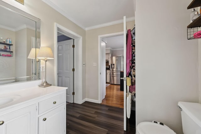 1106 5th Ave, Lawrenceburg, TN 38464 - bathroom with wood finished floors, toilet, ornamental molding, vanity, and baseboards