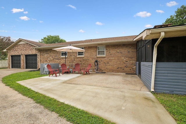1106 5th Ave, Lawrenceburg, TN 38464 - view of patio featuring a garage and driveway