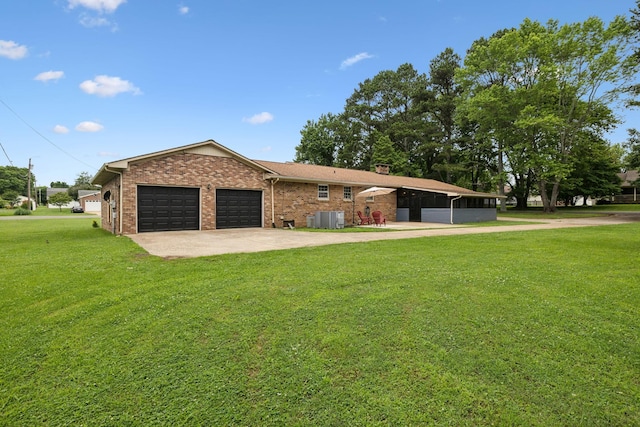 1106 5th Ave, Lawrenceburg, TN 38464 - ranch-style house featuring central air condition unit, an attached garage, concrete driveway, a front yard, and brick siding