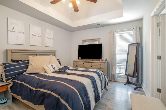 409 Princeton Dr, Lebanon, TN 37087 - bedroom with light wood finished floors, multiple windows, ceiling fan, and a raised ceiling