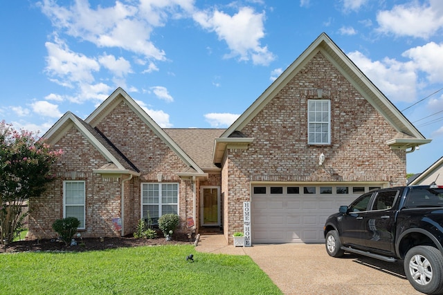 409 Princeton Dr, Lebanon, TN 37087 - traditional-style house featuring concrete driveway, brick siding, a front yard, an attached garage, and roof with shingles
