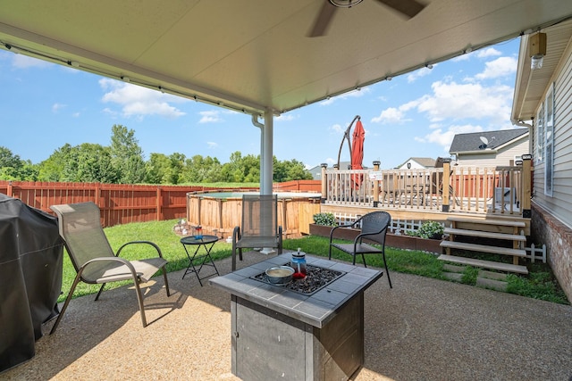 409 Princeton Dr, Lebanon, TN 37087 - fenced backyard featuring a deck, a patio area, ceiling fan, and a fire pit
