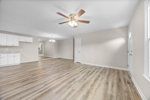 517 Overton Dr, Clarksville, TN 37042 - unfurnished living room with a ceiling fan, light wood-type flooring, a chandelier, and baseboards