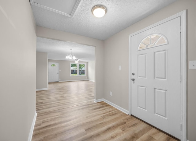 517 Overton Dr, Clarksville, TN 37042 - entrance foyer featuring light wood finished floors, a textured ceiling, baseboards, and a chandelier