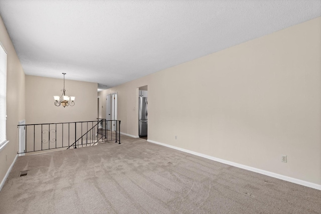 3554 Mountain Creek Rd, Chattanooga, TN 37415 - empty room featuring a chandelier, carpet floors, and baseboards
