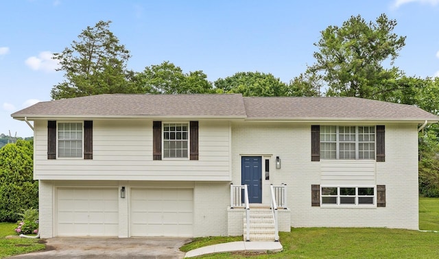 3554 Mountain Creek Rd, Chattanooga, TN 37415 - split foyer home with a front yard, a garage, driveway, and brick siding