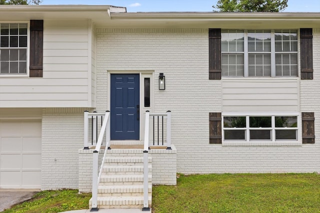 3554 Mountain Creek Rd, Chattanooga, TN 37415 - entrance to property with brick siding, an attached garage, and a yard