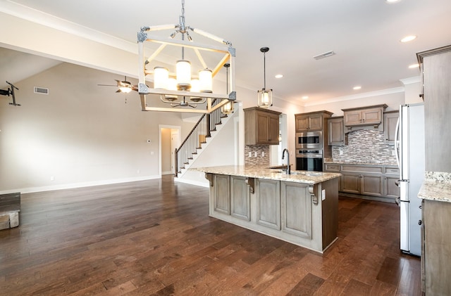 1130 Escalade Ct, Lascassas, TN 37085 - kitchen with stainless steel appliances, a chandelier, tasteful backsplash, light stone counters, and dark wood-type flooring