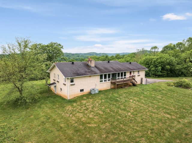 5307 Leipers Creek Rd, Franklin, TN 37064 - back of house featuring a chimney, brick siding, a lawn, and a wooden deck