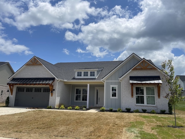 5971 Hunt Valley Dr, Spring Hill, TN 37174 - view of front of home featuring board and batten siding, brick siding, a garage, a front yard, and driveway