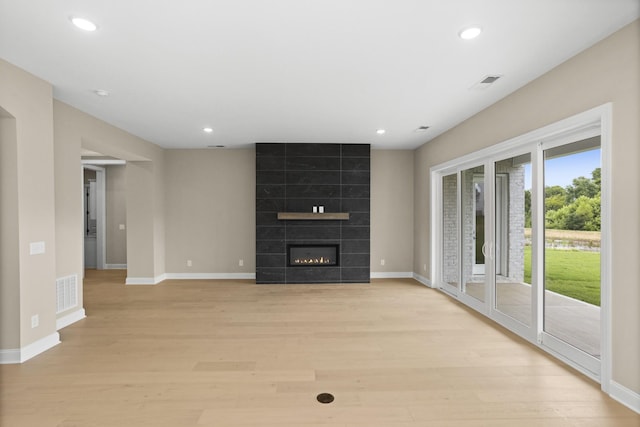 5971 Hunt Valley Dr, Spring Hill, TN 37174 - unfurnished living room with light wood-style flooring, recessed lighting, and a tile fireplace