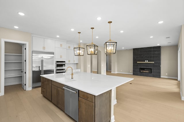5971 Hunt Valley Dr, Spring Hill, TN 37174 - kitchen featuring appliances with stainless steel finishes, white cabinets, light wood finished floors, light countertops, and recessed lighting