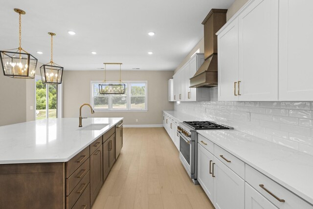 5971 Hunt Valley Dr, Spring Hill, TN 37174 - kitchen featuring appliances with stainless steel finishes, a chandelier, light wood finished floors, white cabinets, and recessed lighting